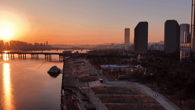 Sunset over a city with a river and bridges