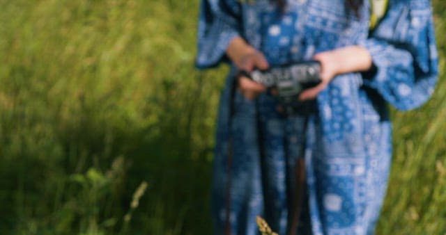 Woman Operating a Camera to Take Pictures