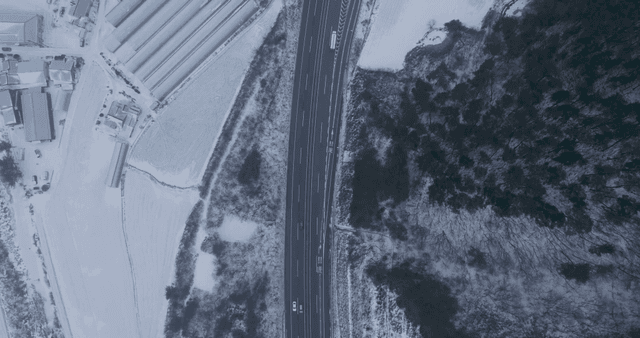Snow-covered road and surrounding fields
