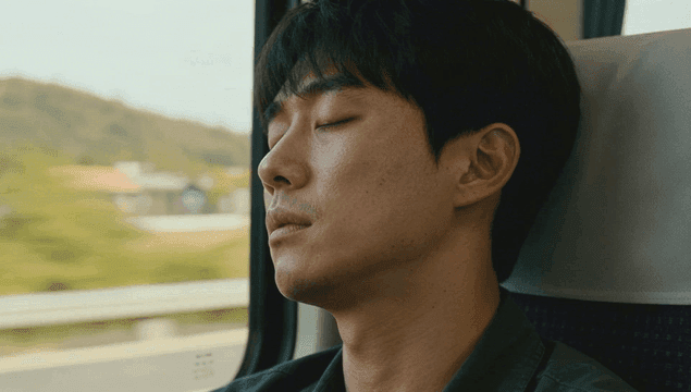 Man sleeping deeply on a train