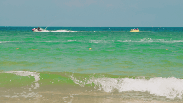 빠른 속도로 바다에서 튜브를 끌고 다니는 제트스키