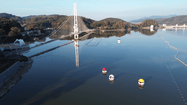 Serene lake with a suspension bridge
