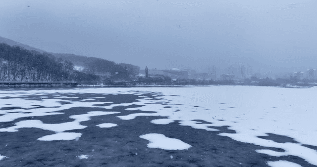 Snow-covered lake with duck boat