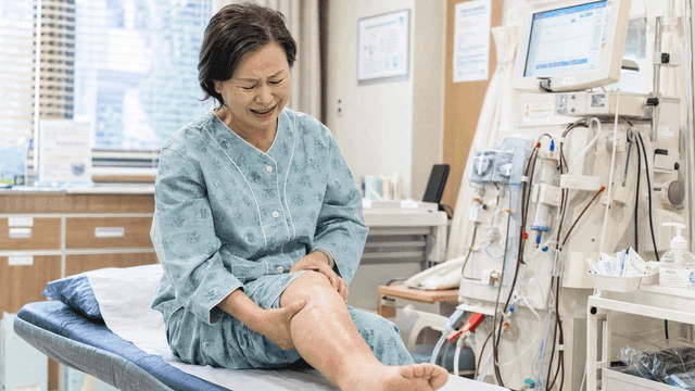 Female patient examining her leg at hospital