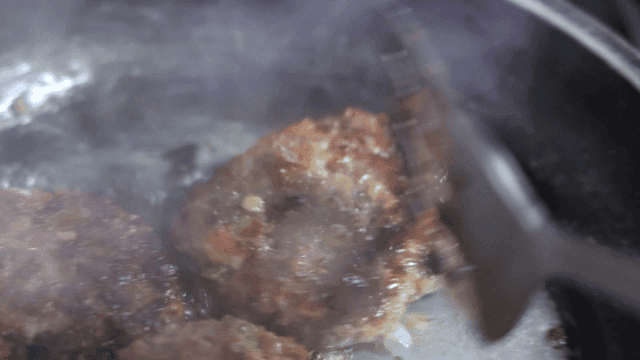 Juicy patties sizzling in a hot pan