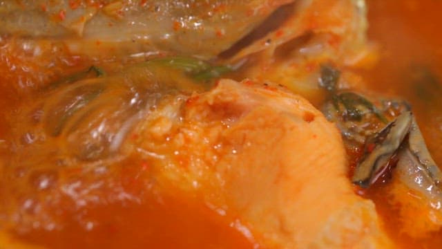 Spicy fish stew with trout boiling in a pot