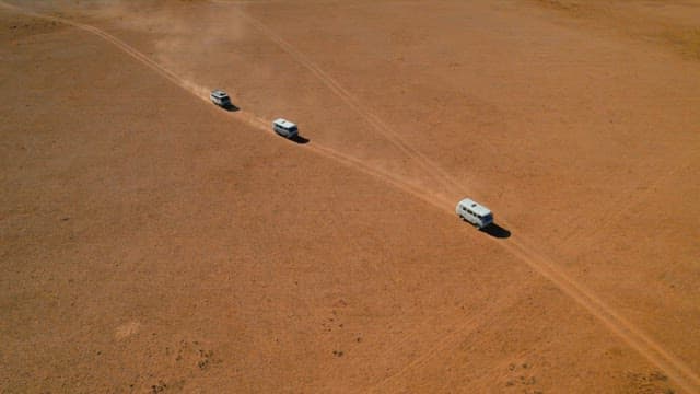 Cars traversing a remote desert