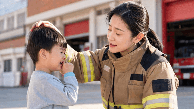 Firefighter comforting a crying child