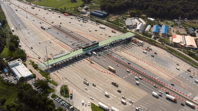 Busy highway tollgate with vehicles