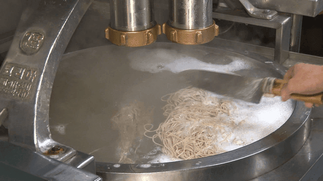 Noodles being extruded from a machine