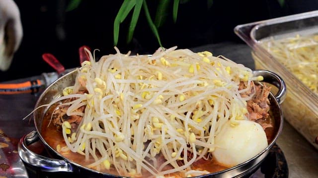 Pork backbone stew topped with chives and bean sprouts