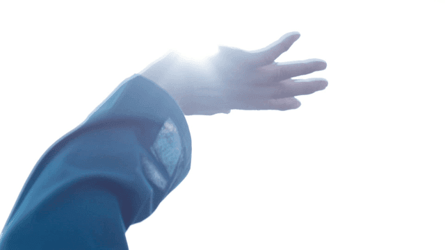 Prisoner reaching out toward bright sunlight