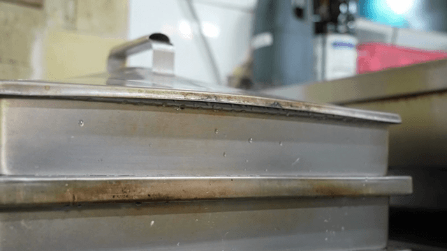 Steam rising from a large metal steamer