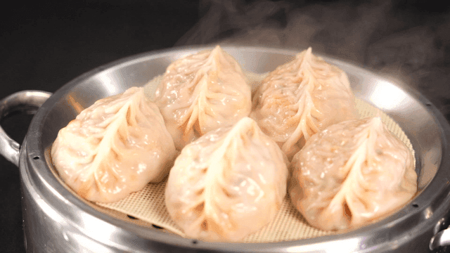 Steamed dumplings in a metal steamer
