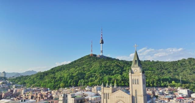 Cityscape with tower and church on mountain