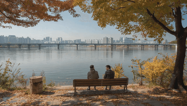 Bench by riverside with autumn trees and bridge