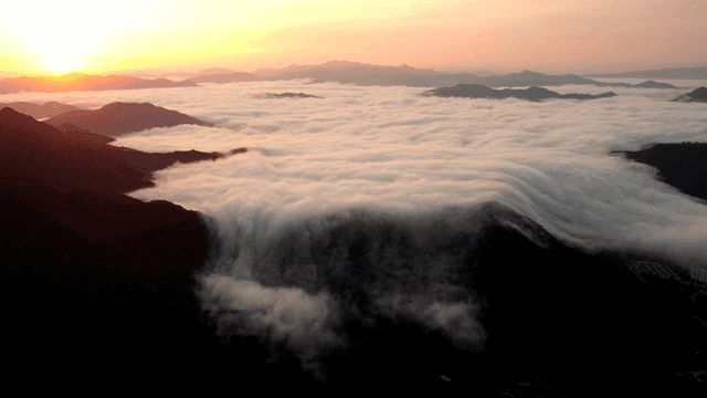 Sunset fading behind sea of ​​clouds