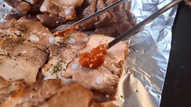 Bossam topped with ssamjang on foil