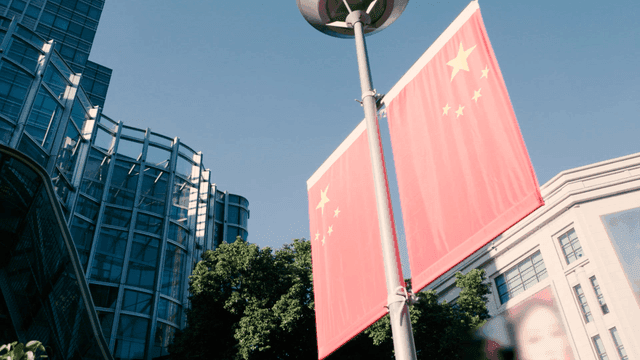 Chinese flag in front of a modern building