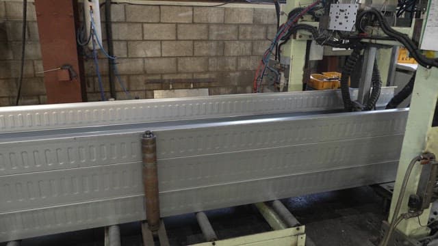 Metal sheet being processed in a factory