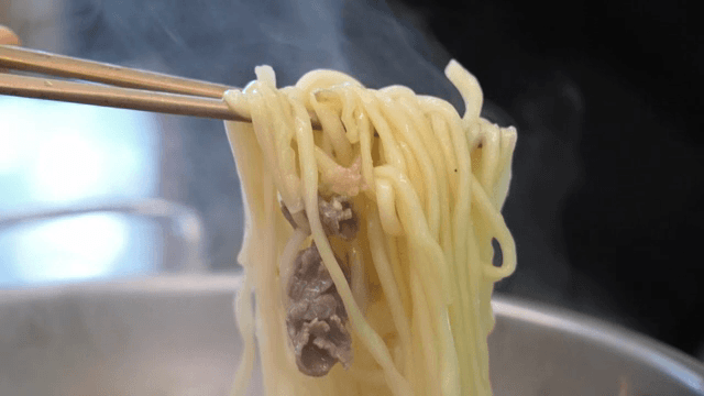 A scene of lifting noodles with chopsticks