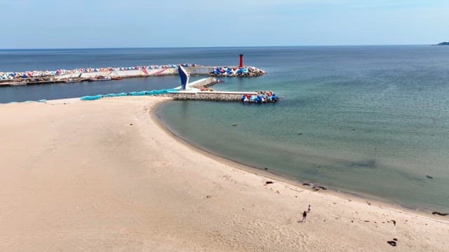 Peaceful beach with a breakwater