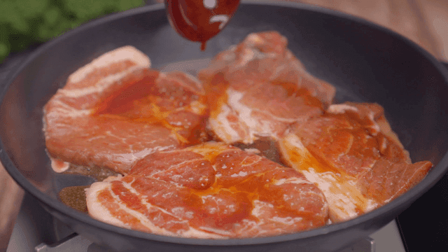 Marinated pork sizzling in a hot pan
