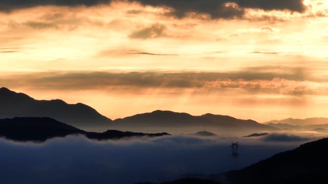 Sunrise over misty mountains