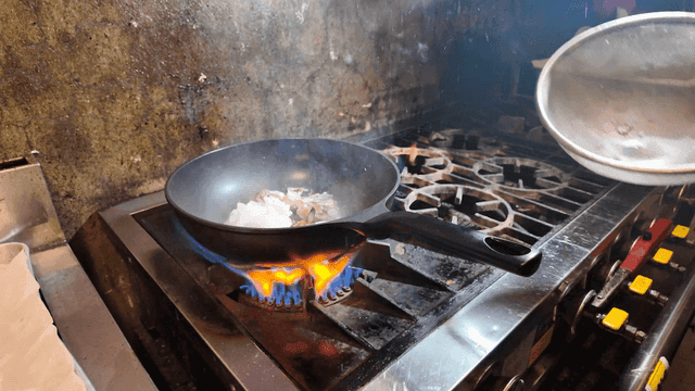 Seafood that catches fire when placed in hot pan