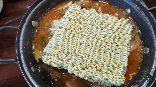 Ramen noodles in boiling spicy stew