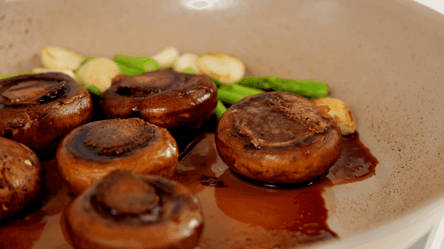 Mushrooms and vegetables cooking in a pan