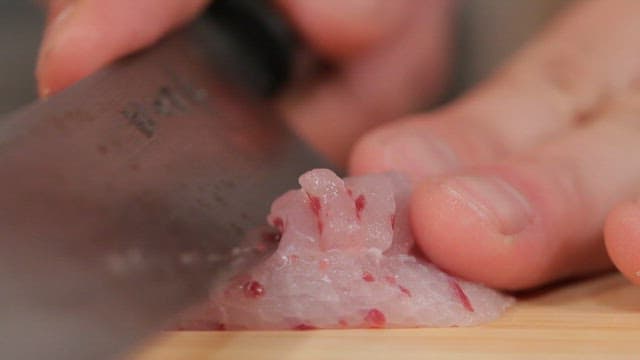 Making sashimi by cutting fresh tingray with a knife