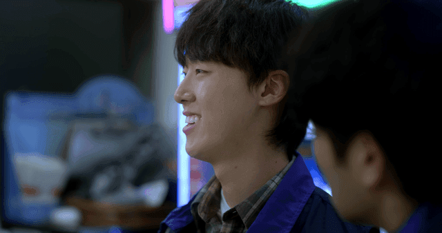 Young man smiling and glaring at man