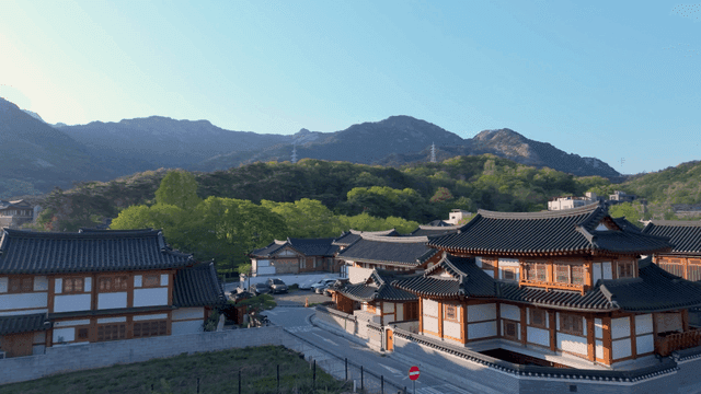 Traditional hanok village with distant mountain view
