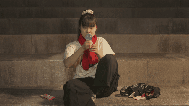 Girl sitting on the stairs holding beads