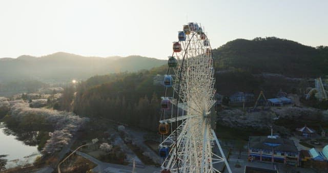 Ferris wheel in a serene amusement park at dusk