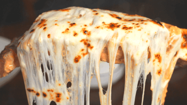 Steak covered in melted cheese