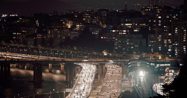 Bustling Nighttime Traffic in a Cityscape