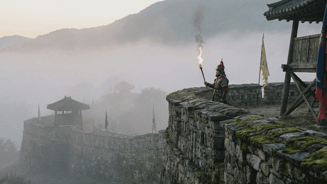 Joseon soldier holding torch on foggy castle wall