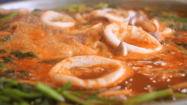 Spicy seafood stew boiling in a pot