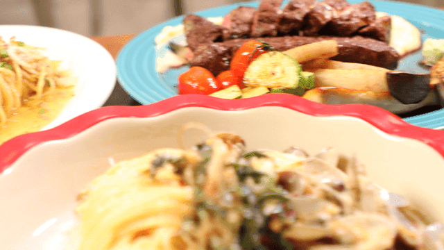 Pasta and steak on table