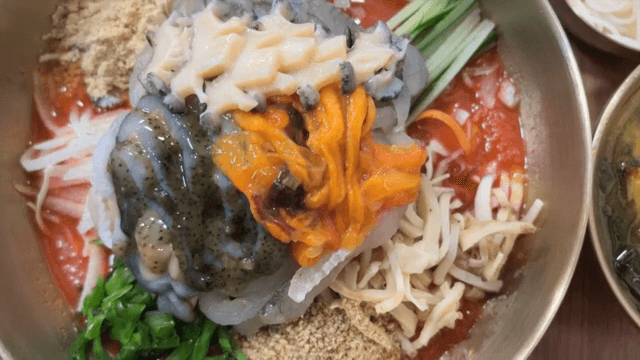 Preparing Cold Raw Fish Soup with fresh abalone on top