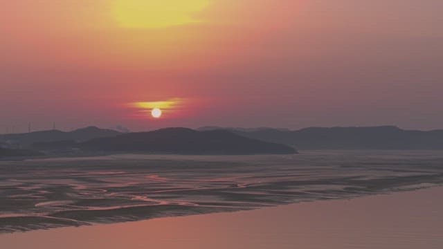 Sunset over a tranquil coastal landscape