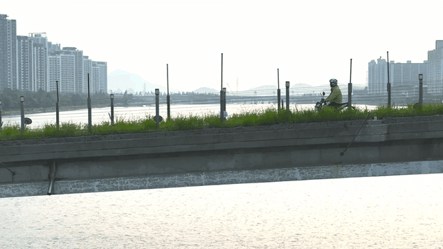 Motorcyclist riding along a riverside