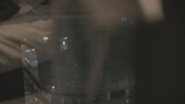 Woman looking out the window at the city night view