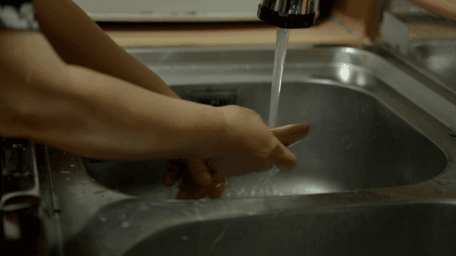 Washing dishes in a kitchen sink