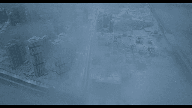 Snow-covered cityscape with fog