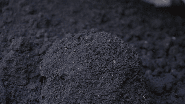 Pile of dark soil in a garden