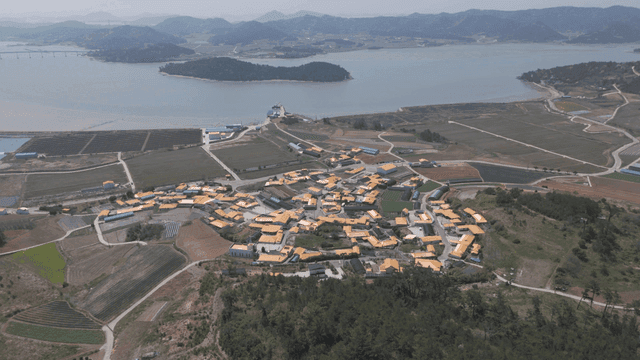 Rural village surrounded by fields and sea