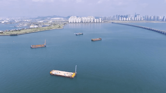 City skyline with ships on a calm sea